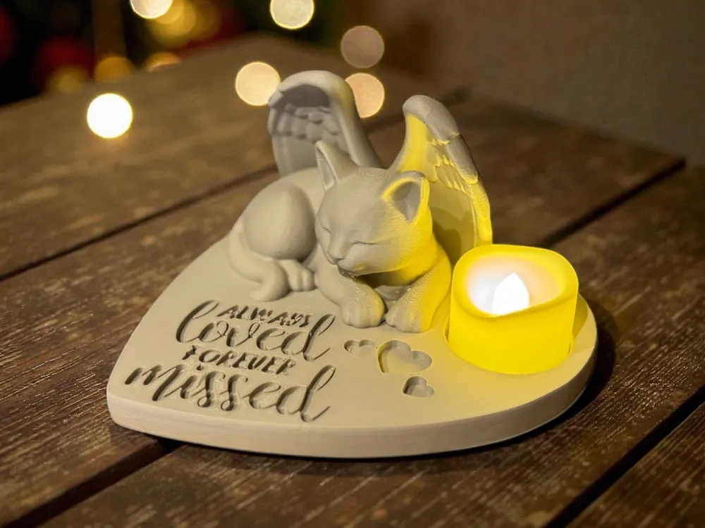 A real 3D print of the Angel Cat Memorial with a glowing tealight